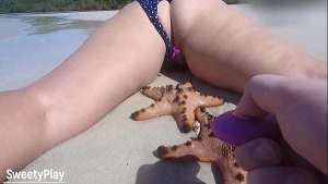 Remote vibrator control on public nude beach