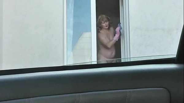 Nude woman neighbor sexy mature Milf without panties and bra washes windows her apartment. A taxi driver watches from car. Solo. Naked in public Peeping Outdoor Outside Publicly Big natural tits Pussy