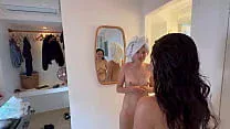 Two women put cream on their naked bodies.