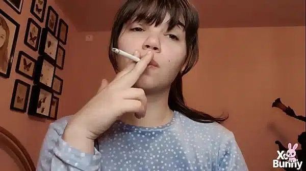 Big lips covered in lipgloss smoking with close up of the lips