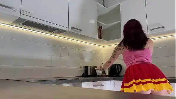 Hottest redhead tattooed cheerleader with over knee socks shows her see through panties in the kitchen