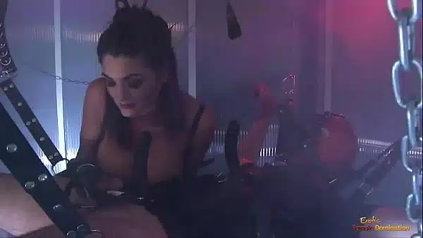 Busty brunette slut teaching a chained dude a lesson with another chick