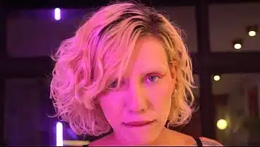 Busty blonde gives a blowjob and handjob backstage