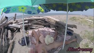 On a nudist beach in Tenerife, the stepdaughter jerks off her stepfather’s cock without shame