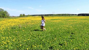 Beautiful Ananta Shakti masturbates pussy on a field with dandelions